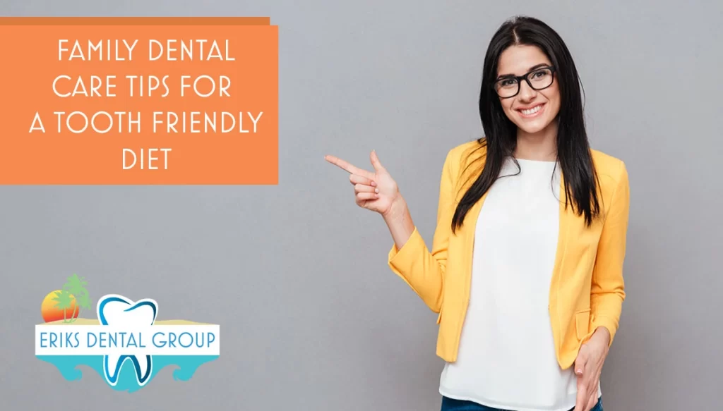 woman with glasses and yellow jacket smiling infront of grey background
