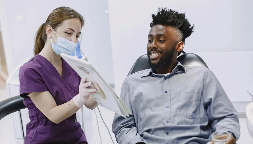 dental professional shows patient a chart