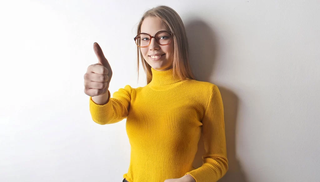 woman smiling with her thumb up
