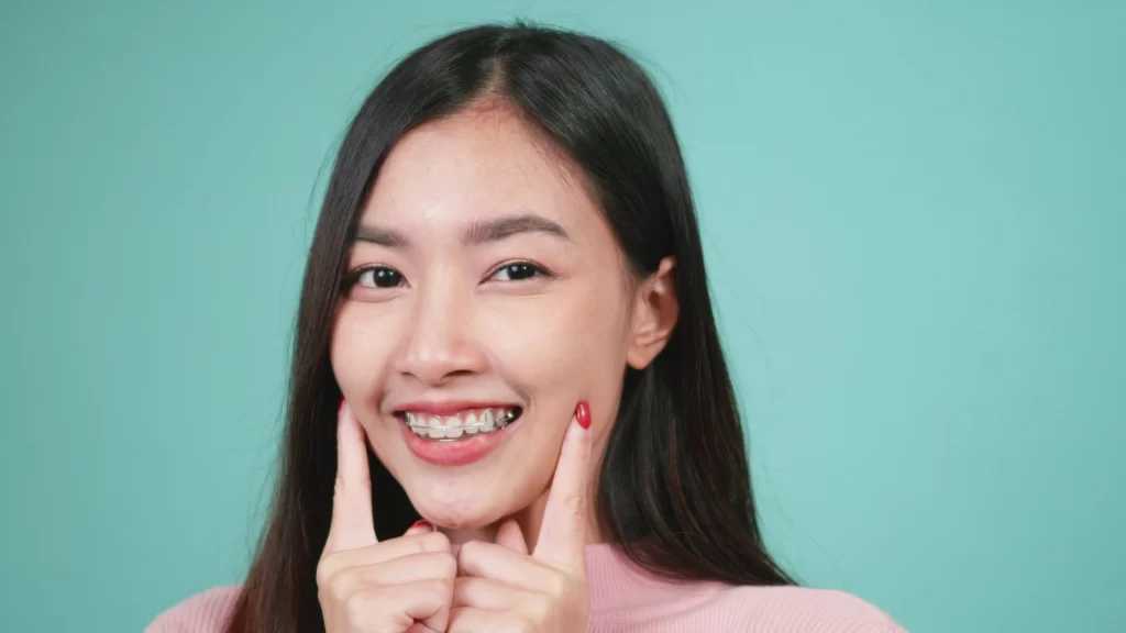 woman smiling pointing at retainer