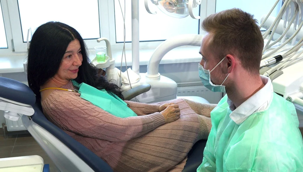 Dentist Speaking with Patient in the dentist chair