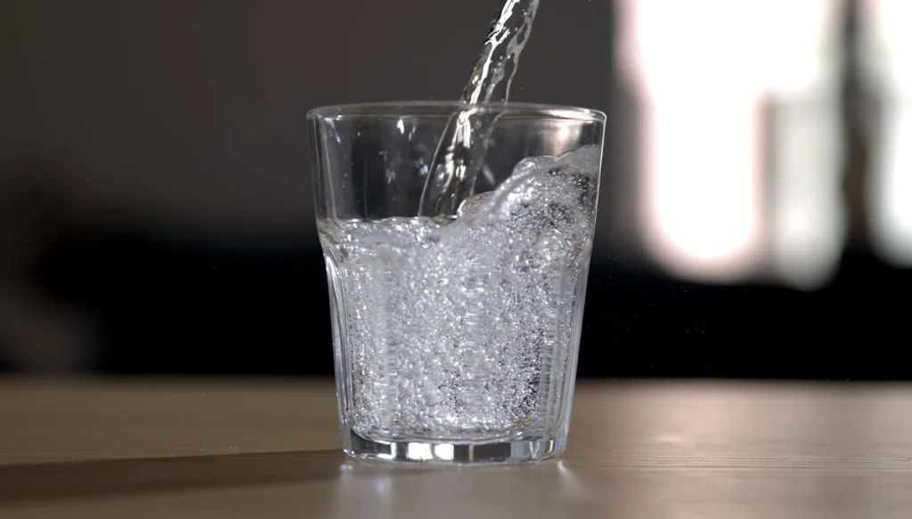 glass with water being poured in