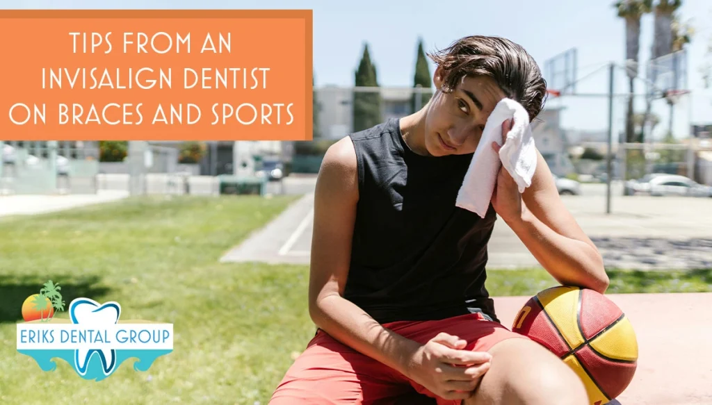 Young man on a sunny day wiping sweat from his forehead sitting next to a basketball